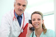 Foto: Doctor posing with his assistant Doctor posing with his assistant