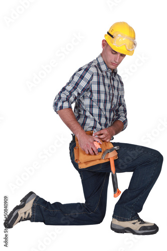 Photo: handyman kneeling handyman kneeling