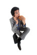 Businessman on the phone eating hamburger