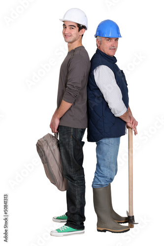 Photo: senior craftsman and young apprentice standing back to back senior craftsman and young apprentice standing back to back