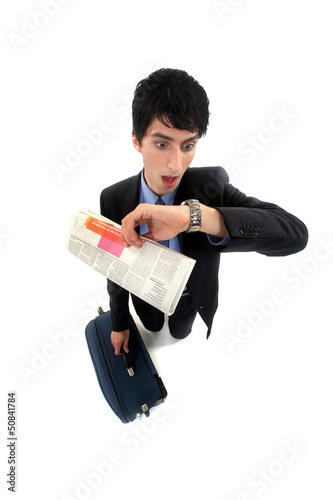 Photo: Stunned businessman looking at the time Stunned businessman looking at the time