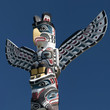 A totem wood pole in the blue cloudy background