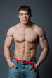 Young attractive muscular man on a black background