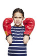 Young girl wearing boxing gloves angry