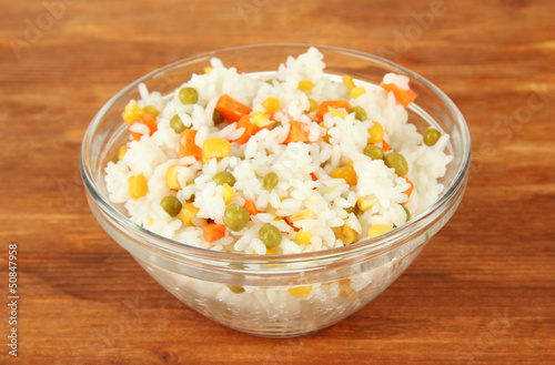 Photo: Risotto in bowl on wooden background Risotto in bowl on wooden background