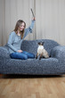 happy young woman playing with cat