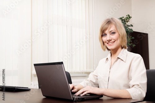 Photo: Young woman working with computer Young woman working with computer