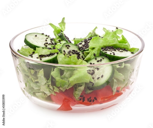 Photo: Salad of cucumber with sesame seeds in bowl isolated on white Salad of cucumber with sesame seeds in bowl isolated on white