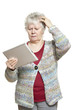 Senior woman using tablet computer looking confused
