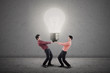 Businessmen holding light bulb