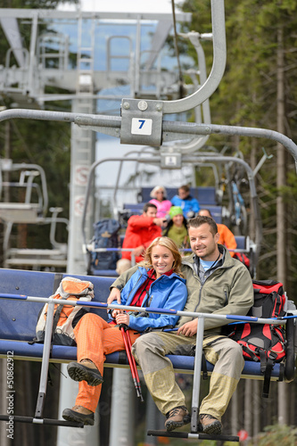 Photo: Lovely couple sitting on chairlift Lovely couple sitting on chairlift