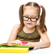 Little girl is reading a book