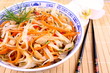 Rice noodle with chicken meat, chopsticks and orchid