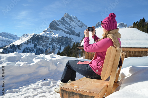 Photo: Girl with a camera in Swiss Alps Girl with a camera in Swiss Alps