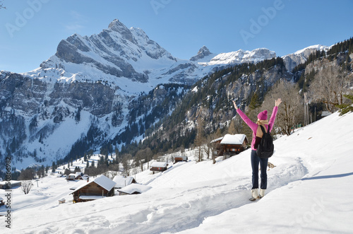 Photo: Traveler enjoying Alpine panorama. Braunwald, Switzerland Traveler enjoying Alpine panorama. Braunwald, Switzerland