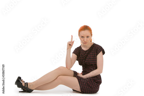 Photo: Woman pointing above her head Woman pointing above her head