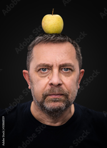 Photo: man with a green apple on his head man with a green apple on his head