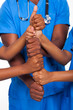 african american healthcare workers hands together