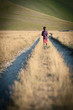 Kid walking alone outdoors. Castelluccio di Norcia, Italy.