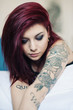 Sensual portrait of beautiful girl with tattoo lying on bed.