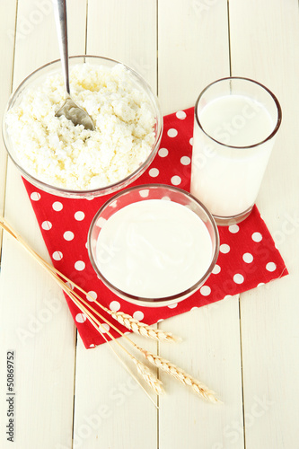 Photo: Dairy produce on a light wooden table Dairy produce on a light wooden table