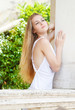 Girl in the long white dress in the summer day