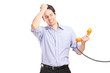 Young man in trouble holding a telephone tube
