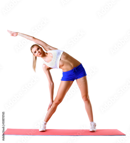 Photo: Beautiful woman practices aerobics in studio Beautiful woman practices aerobics in studio