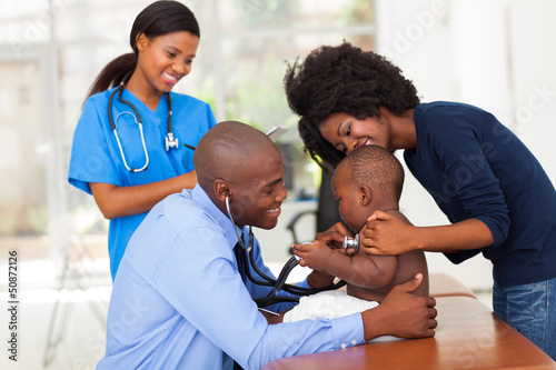 Photo: african mother and her son in doctor's office with doctor and nu african mother and her son in doctor's office with doctor and nu
