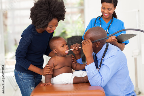 Photo: male african doctor examining little boy male african doctor examining little boy