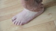 man massaging his foot and ankle