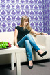 The fashionable girl on a light sofa