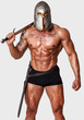 Hot warrior in black pants is holding sword in his shoulder
