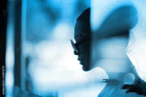 Photo: Fashion woman profile silhouette behind glass Fashion woman profile silhouette behind glass