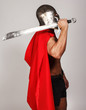 Sideview of shirtless warrior who is holding his sword