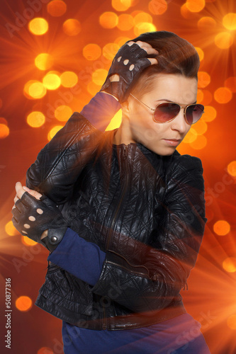 Photo: Hit rock diva in orange spotlights Hit rock diva in orange spotlights