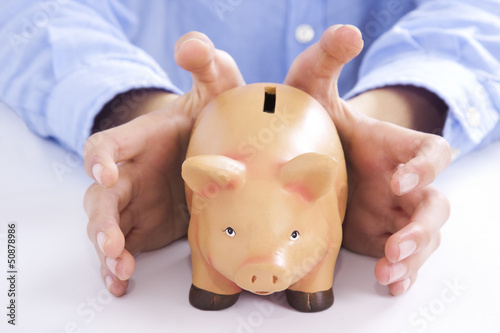 Photo: manos con la hucha de los ahorros manos con la hucha de los ahorros