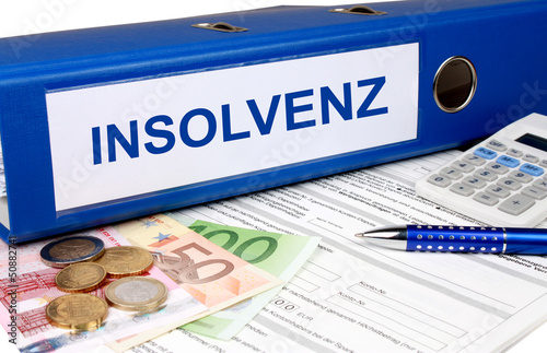 Photo: Insolvenz Ordner mit Geld und Taschenrechner Insolvenz Ordner mit Geld und Taschenrechner