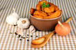 Appetizing village potatoes in bowl on beige tablecloth
