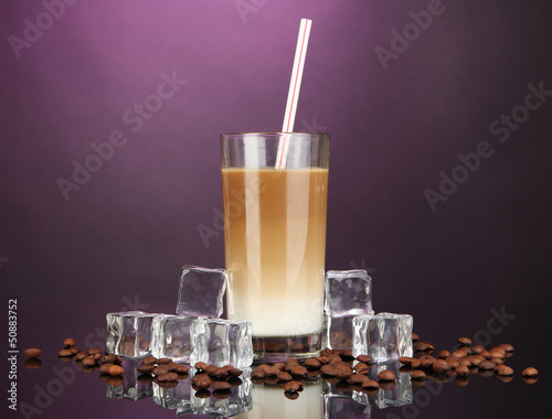 Photo: Cold coffee with ice in glass on color background Cold coffee with ice in glass on color background