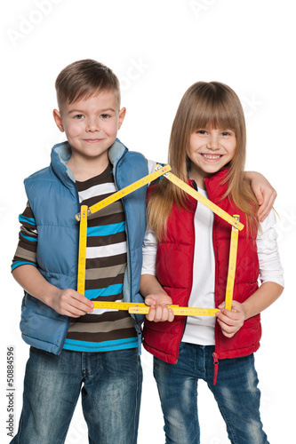 Photo: Children are holding model of a house Children are holding model of a house