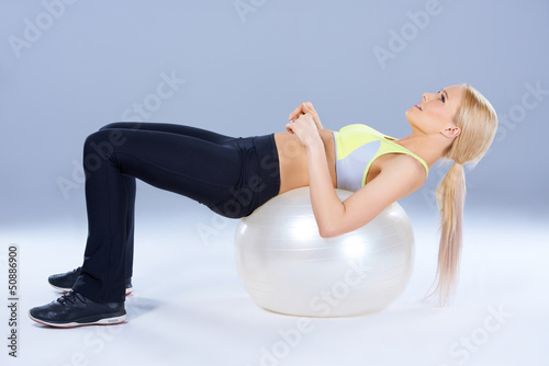 Photo: Spotty woman lying on fitness ball Spotty woman lying on fitness ball