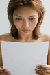 Young woman reading a letter.