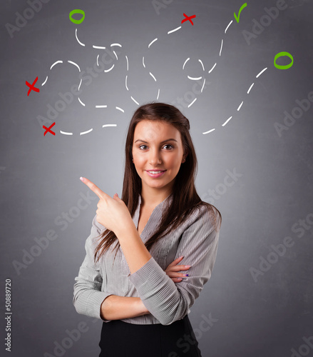 Photo: Young woman thinking with abstract marks overhead Young woman thinking with abstract marks overhead
