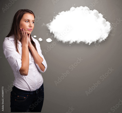 Photo: Pretty lady thinking about cloud speech or thought bubble with c Pretty lady thinking about cloud speech or thought bubble with c