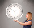 Attractive lady holding a huge clock