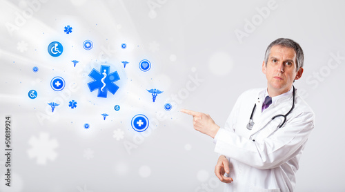 Photo: Doctor with blue medical icons Doctor with blue medical icons