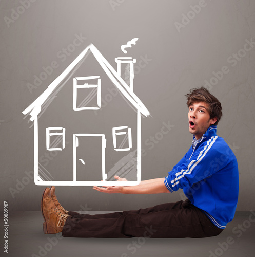 Photo: Young boy holding a huge drawn house Young boy holding a huge drawn house