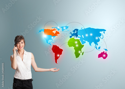 Photo: young woman making phone call with colorful world map young woman making phone call with colorful world map