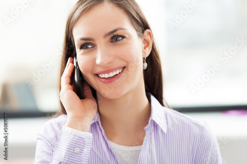 Photo: Businesswoman using mobile phone Businesswoman using mobile phone